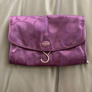 Purple Coach cosmetic bag